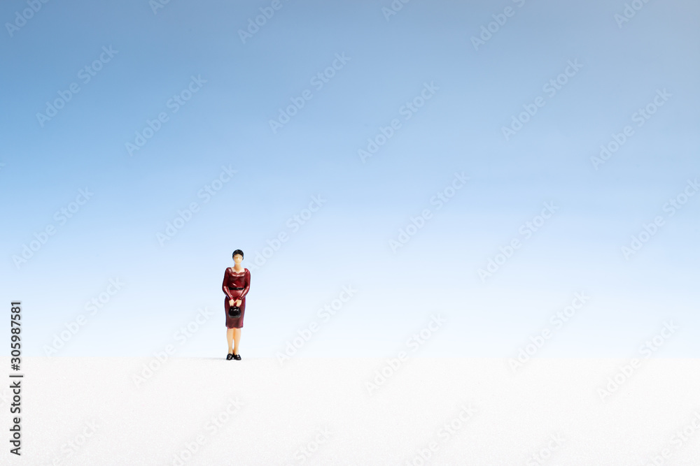 Lonely woman concept. Woman miniature on abstract space Lonely woman concept. Woman miniature on abstract space