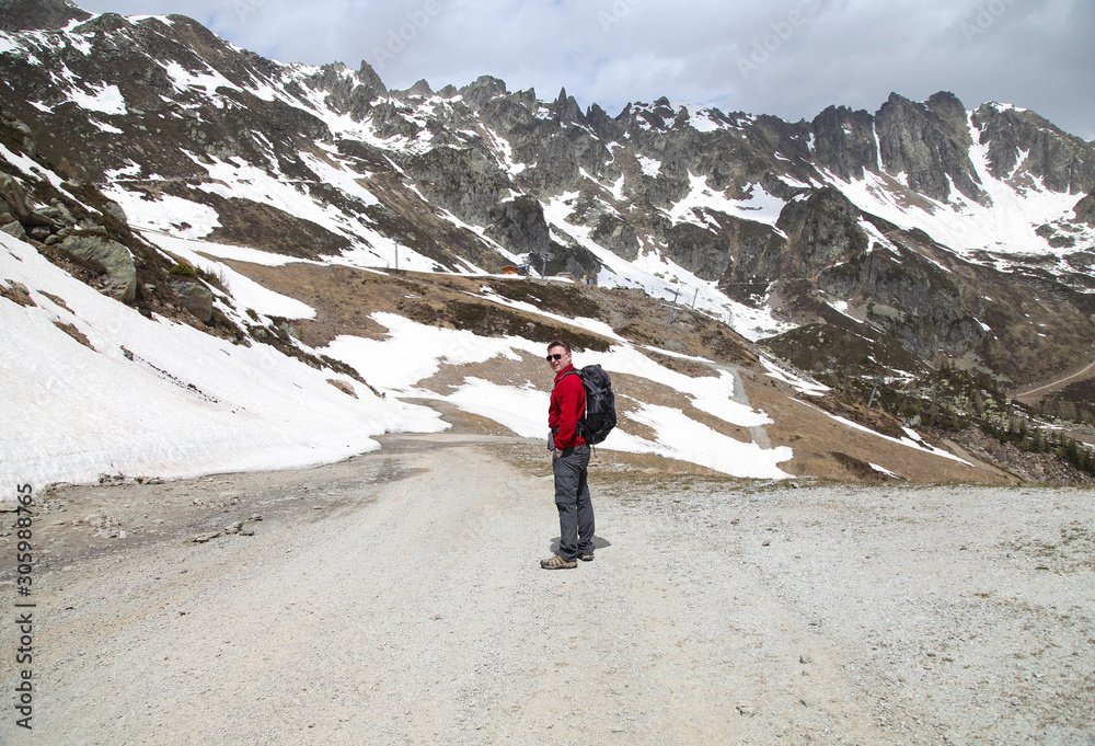 Naklejka premium Tourist hiking in snow mountains