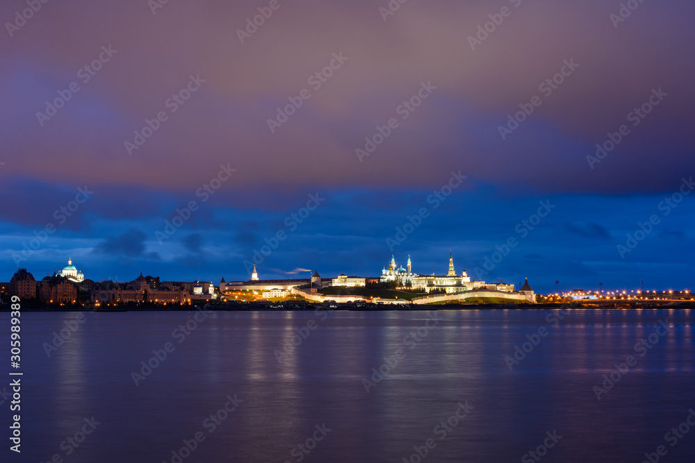 Kazan Kremlin with Presidential Palace, Annunciation Cathedral, Soyembika Tower, Qolsharif Mosque from the embankment near the center family and marriage with the bright blue sky at night.