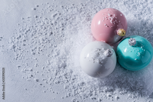 color christmas balls on a snow background