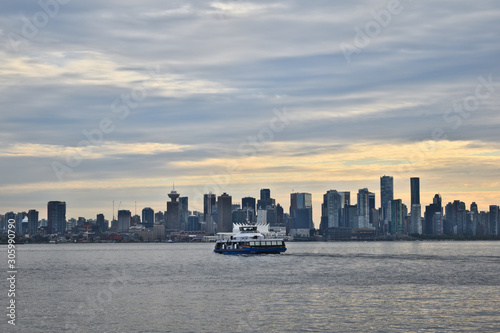 Vancouver skyline on a summer evening sunset with ferry. View from North Vancouver.