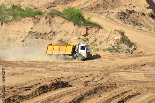 Dump truck transports sand and other minerals in the mining quarry. photo