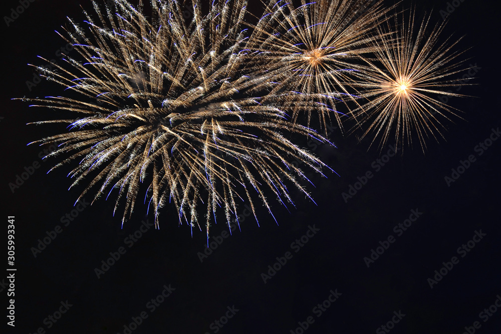 Veriety colorful fireworks on the night sky background. Salute with yellow flashes. holiday and fun concept