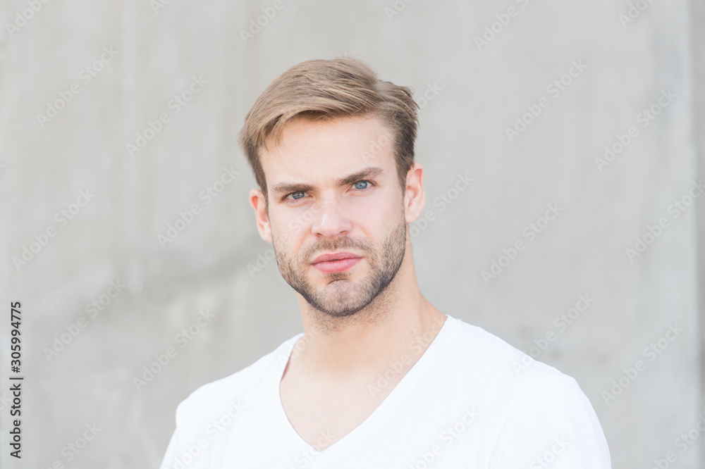 Obraz premium Love yourself. portrait of male attractiveness. young sexy guy gray background. unshaved macho man. summer male fashion. student unshaven face stylish hairstyle. Bearded man casual style