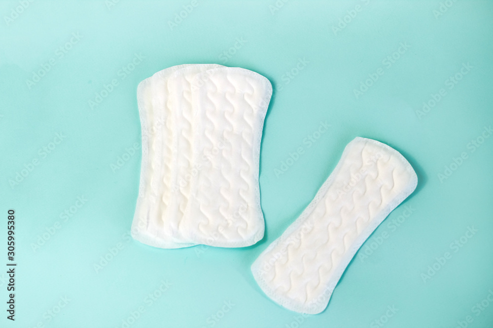 flat lay of feminine hygiene items. Details for critical women's days on a turquoise background. Gaskets for women, health flat lay of feminine hygiene items. Details for critical women's days on a turquoise background. Gaskets for women, health
