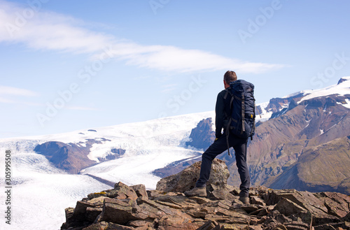 Male hiker relaxing in beautiful mountains, Iceland, Europe.