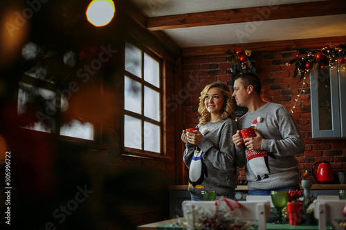husband and wife drink tea in the kitchen