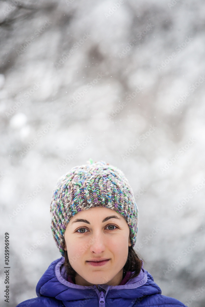 Portrait of a woman in a knitted hat.