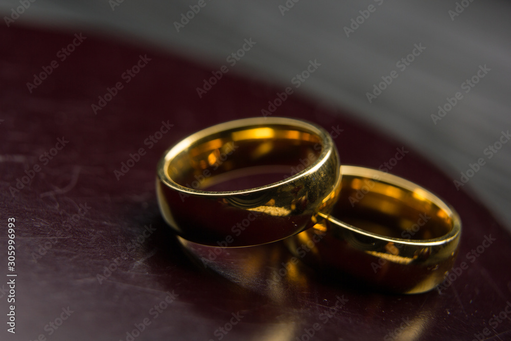 Divorce and separation concept. Two golden wedding rings, judge gavel.