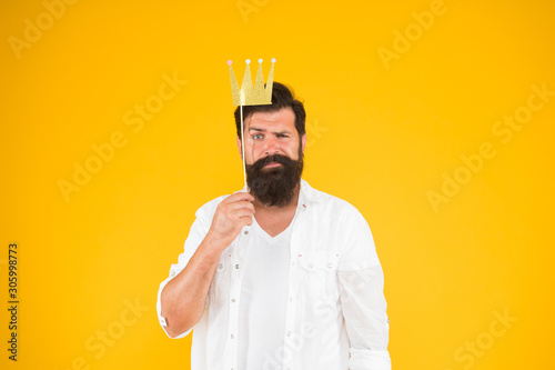 sad bearded man party crown. king of party. royal style. brutal bearded man king. Costume party. happy birthday. hipster booth props yellow background. ready for fun. feeling unhappy for some reason