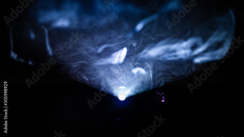 Fotografie smoke infront of a light of projector