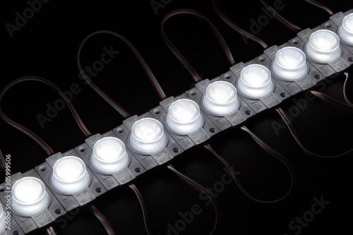 Single cold white led module on black background.