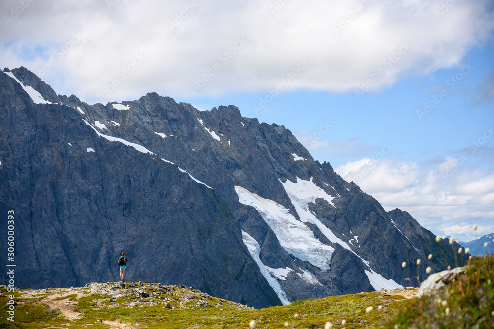 Hiker Stands At The Edge of Ridge