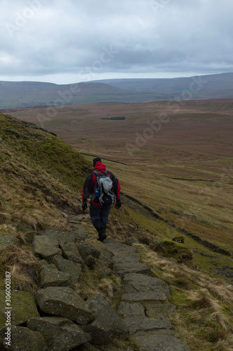 A walker looking out over Pen-y-ghent Valley in the Yorkshire Dales