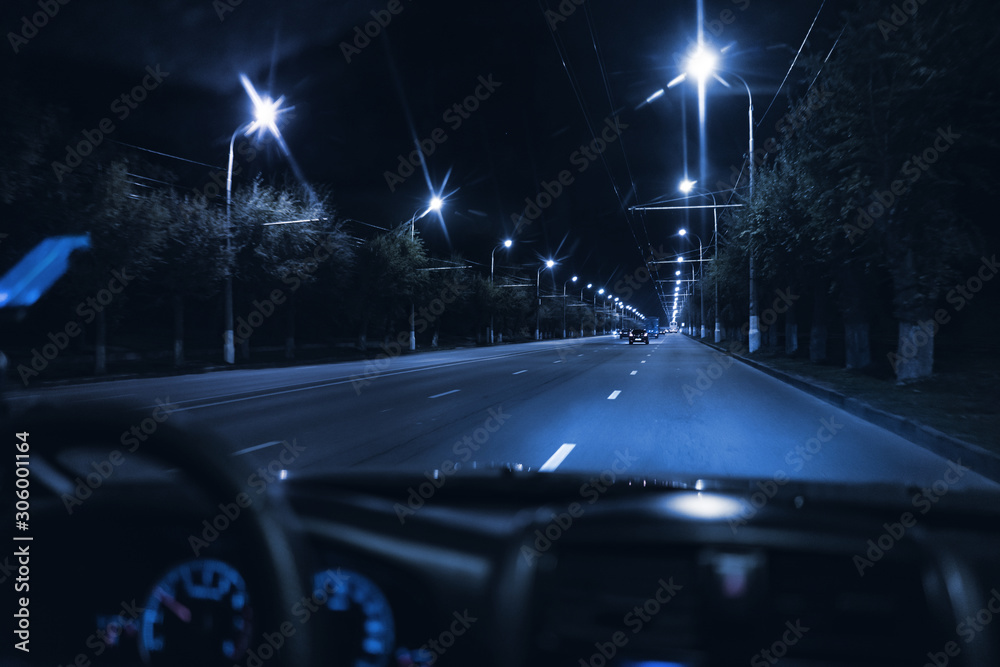 view from inside the car driving at night in the city traffic highway