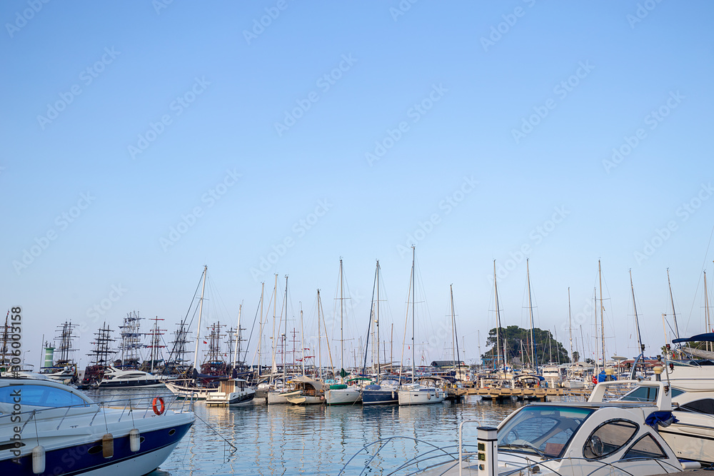Boats on a marina. Yachts at blue sea.