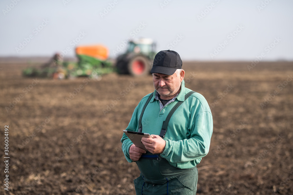 Fototapeta premium Farmer with tablet in field