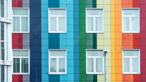 Modern bright rainbow facade of a kindergarten. Multicolor wall of a public building. Positive vibrant architecture. photo