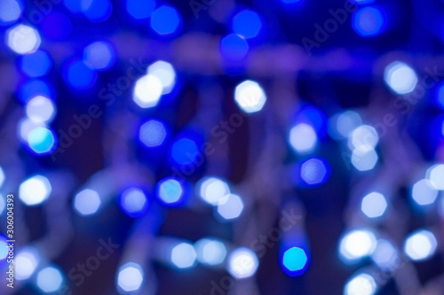 Round white glare on blue background. Abstract textural background. Bokeh