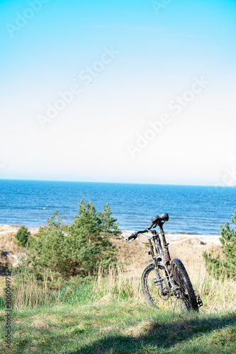 Bicycle standing on dunes by the sea shore with view to the Baltic sea