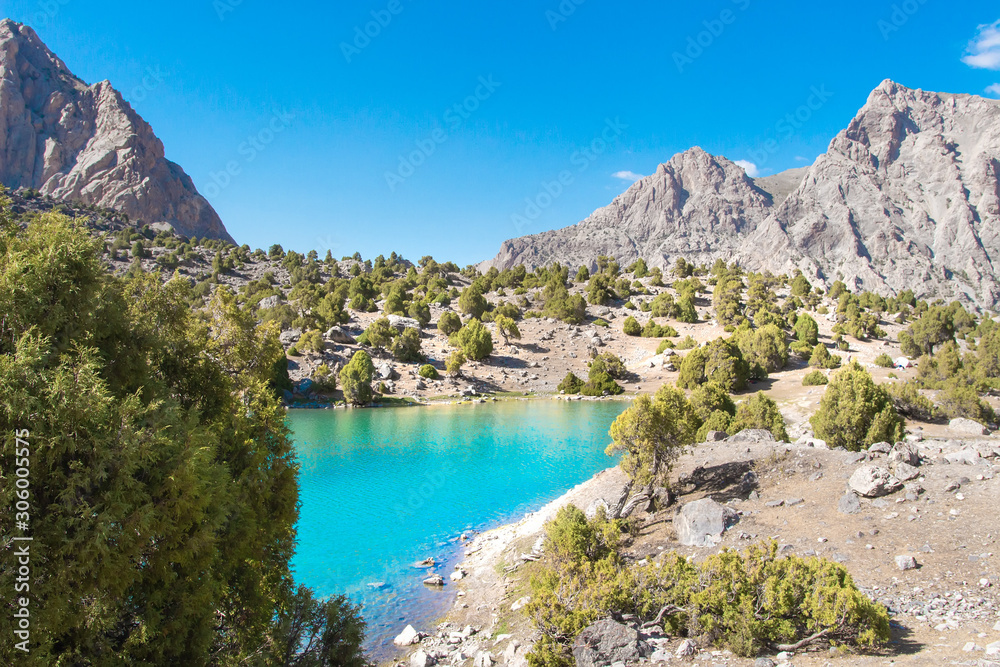 Obraz premium Summer mountains. Scenic landscape of mountain valley with blue lake in Fann mountains, Tajikistan. Amazing view on Kulikalon lake with turquoise water on clear bright day