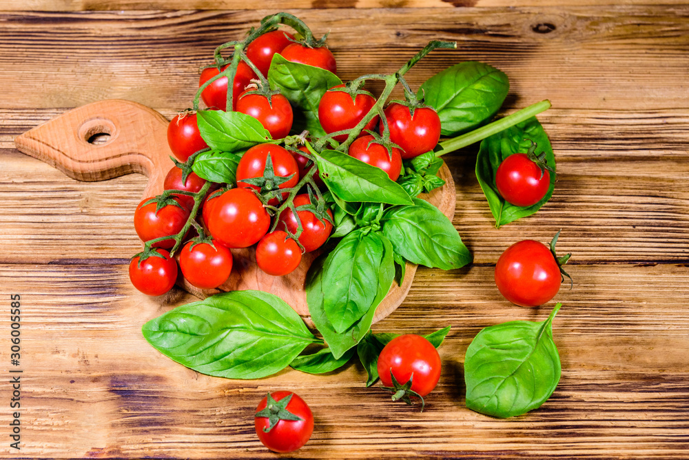 Heap of small cherry tomatoes on wooden table. Top view Heap of small cherry tomatoes on wooden table. Top view