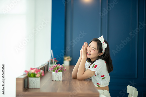 A beautiful Asian woman is cute, bright and she is with beautiful flowers on the weekends.