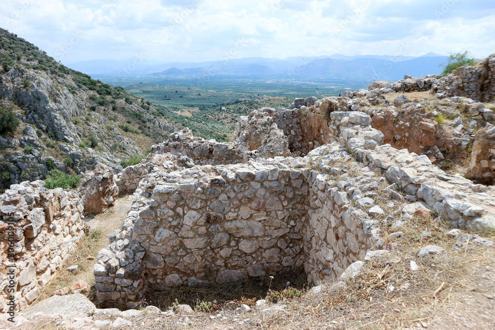 View to the ruins of ancient greek city Mycenae with the beautiful valley on the background, Peloponnese, Greece