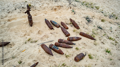 Photography old rusty artillery shell and aircraft projectile in the desert