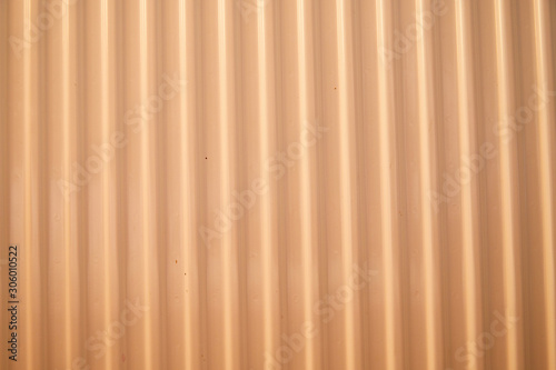 Aluminum fence. Corrugated metal profiled panel. Background of orange metal siding, corrugated iron sheet for decoration