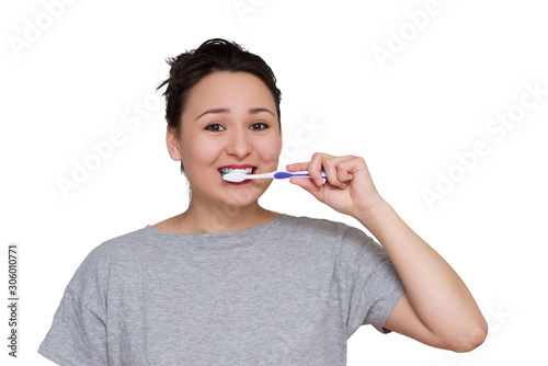 a pretty young girl brushing her teeth photo