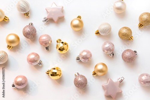 Christmas background with golden and pink glitter balls on white. Top view. Xmas pattern. New Year. Greeting card. © svetlana_cherruty