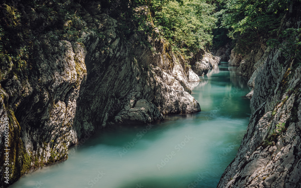 The nature of the Sochi National Park near the Black Sea. Canyon of white cliffs with turquoise water. Tourism in southern Russia. Emerald mountain stream in the Caucasus. The nature of the Sochi National Park near the Black Sea. Canyon of white cliffs with turquoise water. Tourism in southern Russia. Emerald mountain stream in the Caucasus.