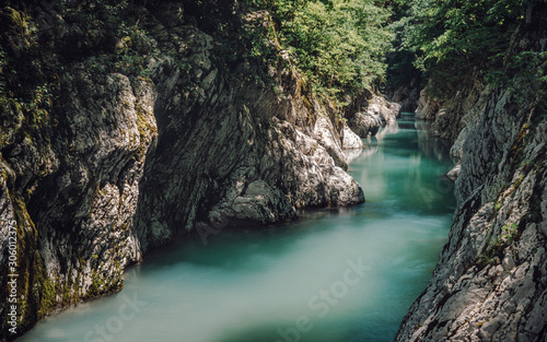 The nature of the Sochi National Park near the Black Sea. Canyon of white cliffs with turquoise water. Tourism in southern Russia. Emerald mountain stream in the Caucasus.