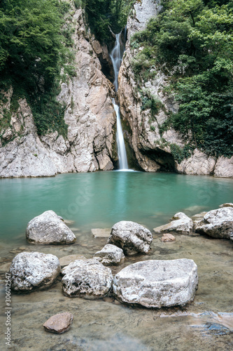 The nature of the Sochi National Park near the Black Sea. Agur waterfalls with turquoise water. Vertical photo. Tourism in the Krasnodar region, southern Russia. photo