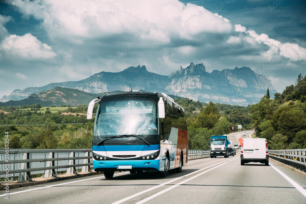 Spain. Touristic Bus Car Goes On Motorway Freeway Highway Road On Background Of Spanish Montserrat Mountain Nature Landscape