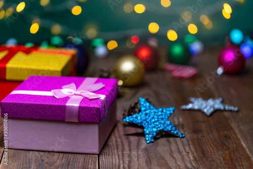 Christmas gift box with christmas balls and cones on a wooden table