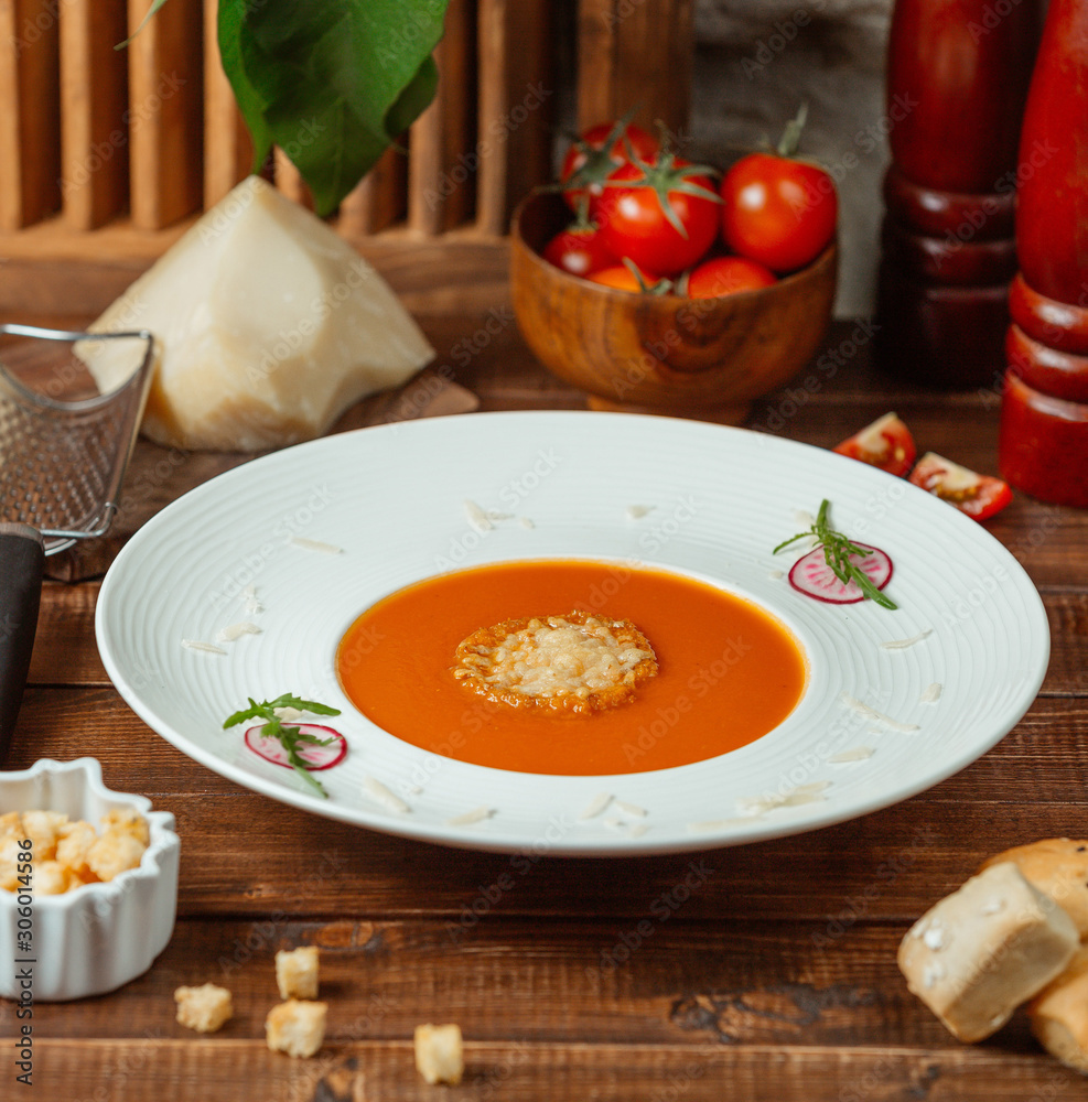 tomato soup with cheese on the table tomato soup with cheese on the table