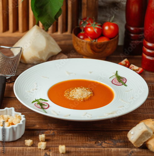 tomato soup with cheese on the table