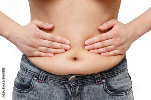 hands woman presses excess fat on the sides of the abdomen. on white background, front view © mikhail_b_azarov