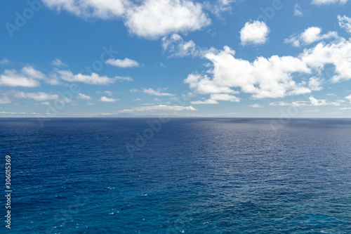 Wide, peaceful, blue ocean landscape under a sunny blue sky with white clouds, Oahu, Hawaii, USA
