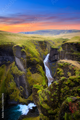 Amazing nature of Iceland. Impressive view on picturesque canyon Fjadrargljufur with colorful sky and reflections. Tipical Icelandic scenery during sunset. Iconic location for landscape photographers.