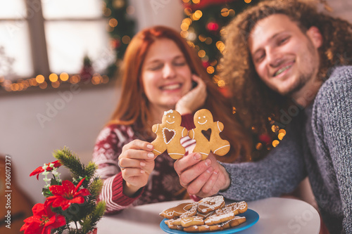 Couple holding Christmas gingerbread cookies