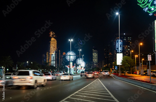 Abu Dhabi downtown Corniche road decorated for the UAE national day celebration at night © creativefamily