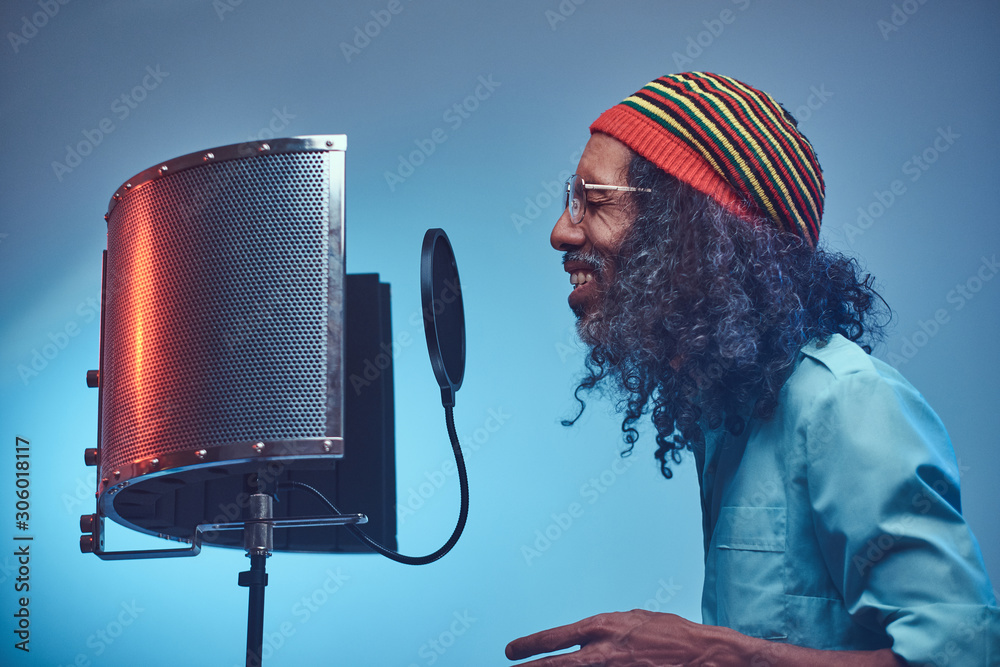 African Rastafarian singer male wearing a blue shirt and beanie ...