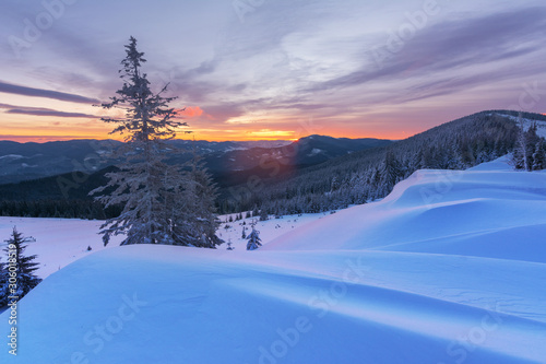 Colorful winter dawn on the mountain valleys in the Ukrainian Carpathian Mountains. 