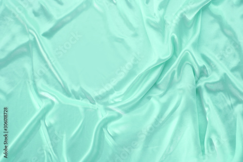 beautiful turquoise silk fabric draped with small folds, soft flowing, luxury concept, wedding, copy space