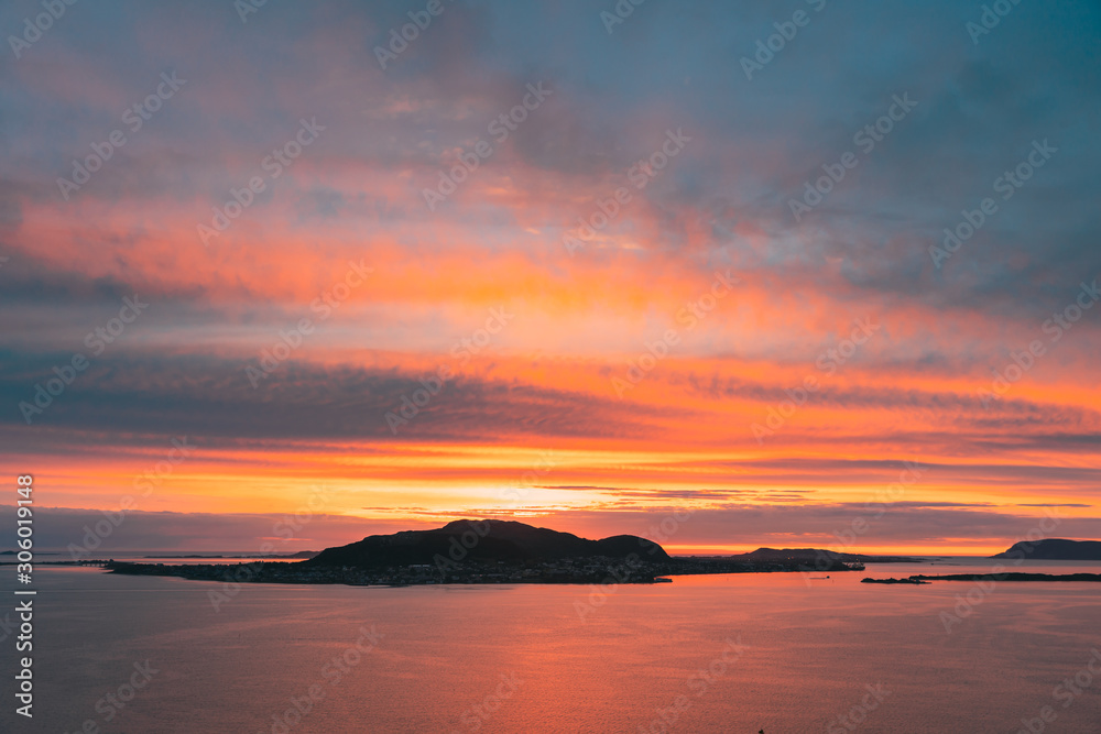 Alesund, Norway. Amazing Natural Bright Dramatic Sky In Warm Colours Above Alesund Valderoya And Islands In Sunset Time. Colorful Sky Background. Beauty In Norwegian Nature Alesund, Norway. Amazing Natural Bright Dramatic Sky In Warm Colours Above Alesund Valderoya And Islands In Sunset Time. Colorful Sky Background. Beauty In Norwegian Nature