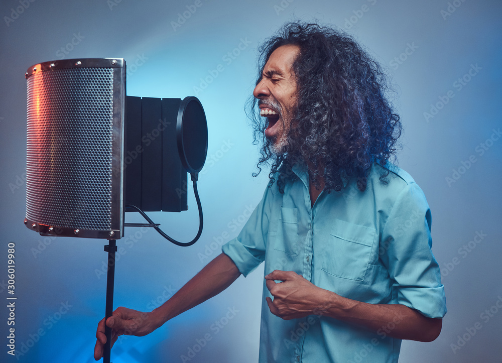 African vocal artist sings a song loudly next to a microphone condenser