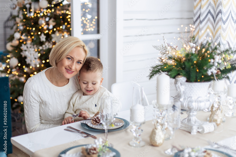 mom and son woman boy dinner christmas in the kitchen at the table playing morning new year's eve decorated atmosphere european nationality sweaters dining room table setting toddler mom and son woman boy dinner christmas in the kitchen at the table playing morning new year's eve decorated atmosphere european nationality sweaters dining room table setting toddler